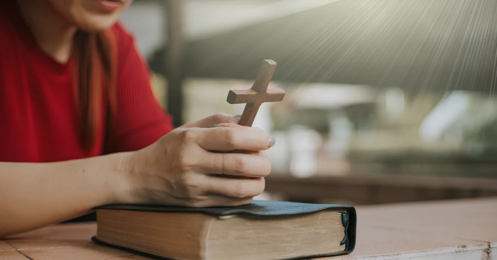 An image showing a Bible with a cross, symbolizing redemption and God's grace.