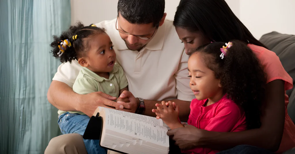 An image showing a family studying Bible lessons about faith.