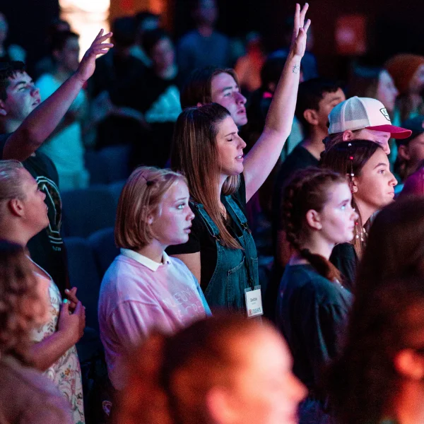 Image of a older and younger people together in church.
